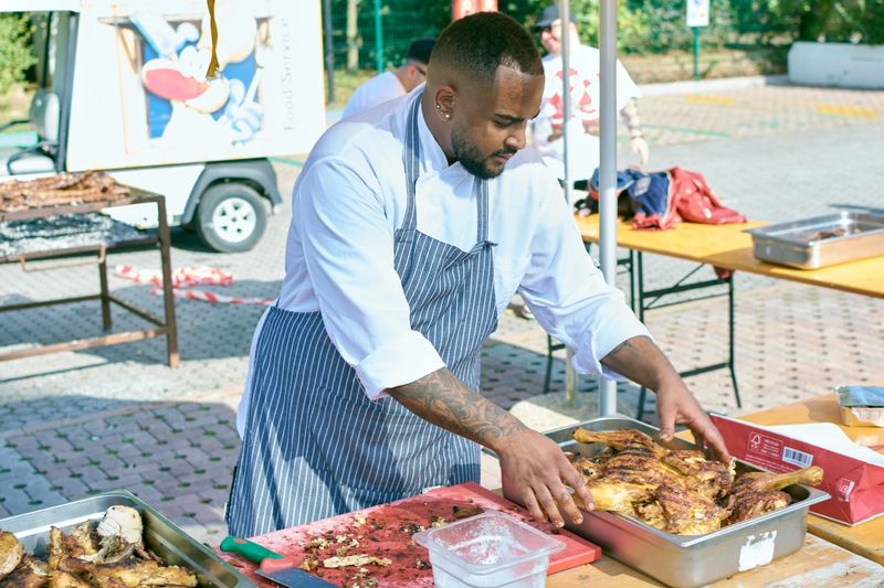 Head chef preparing fresh daves hot chicken dishes in the kitchen