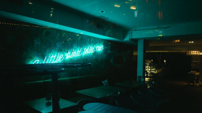 Neon-lit bar area inside Dave's hot chicken restaurant in Lakewood